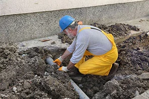 plumber-fixing-sewerage-pipe-feat