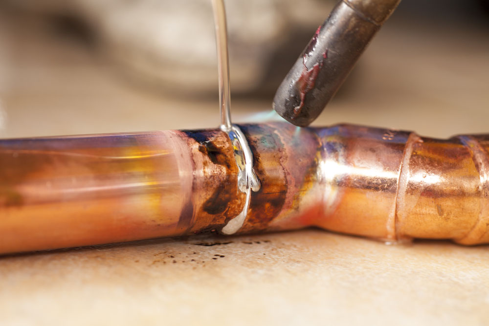 Soldering,Copper,Pipes,With,Tin,And,Torch soldering copper pipes with tin and torch
