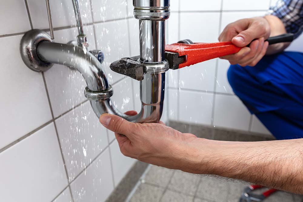 Male,Plumber's,Hand,Repairing,Sink,Pipe,Leakage,With,Adjustable,Wrench Male Plumber's Hand Repairing Sink Pipe Leakage With Adjustable Wrench
